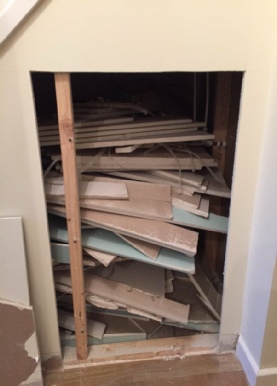 Rubbish hidden by house builder understairs