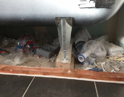 Rubbish under bath left by builder